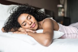 Young woman resting on bed