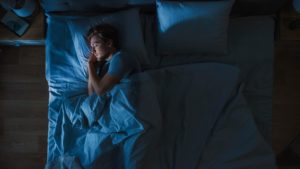 Why Do We Need Sleep? man sleeping in bed