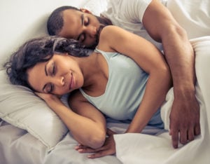 A man and a woman sleep