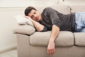 man sleeping on couch