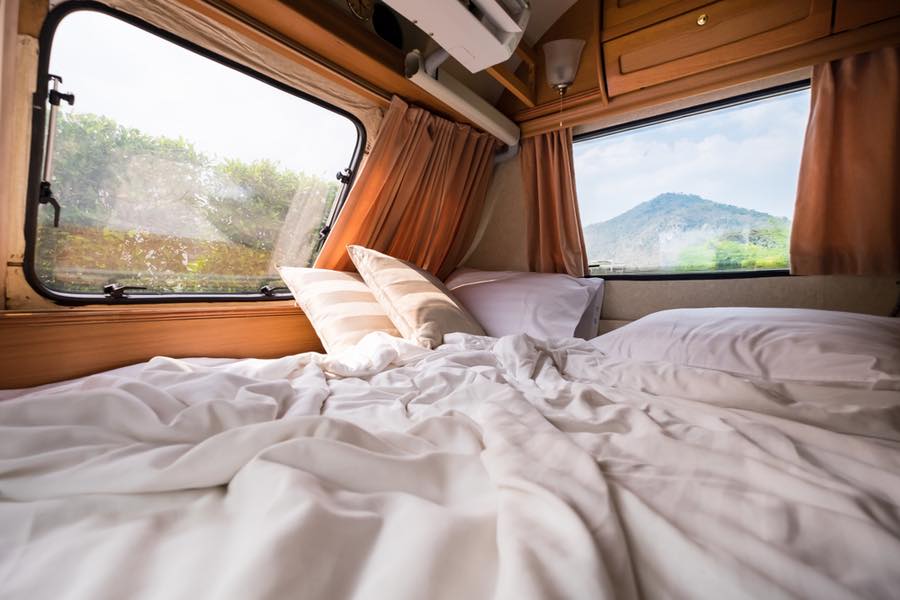 Bed inside an RV with windows