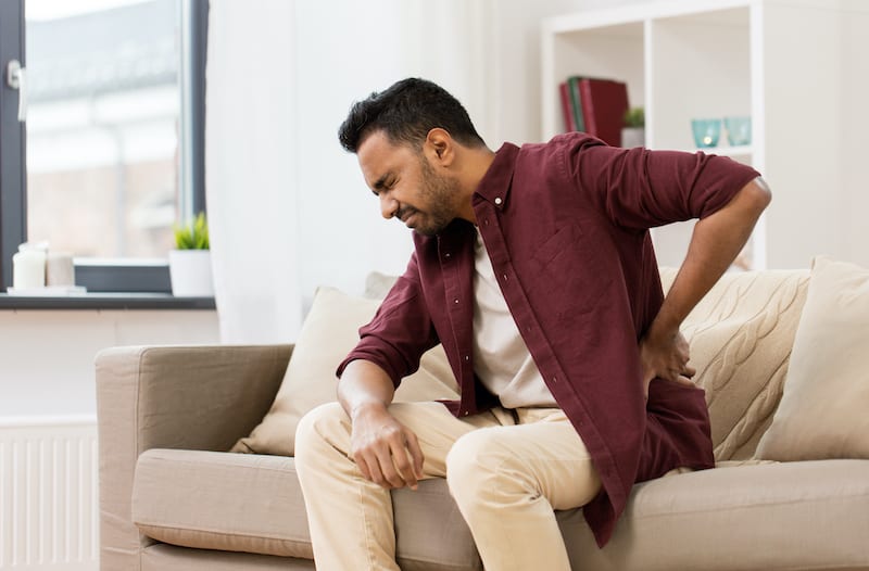 man with back pain who needs pillow