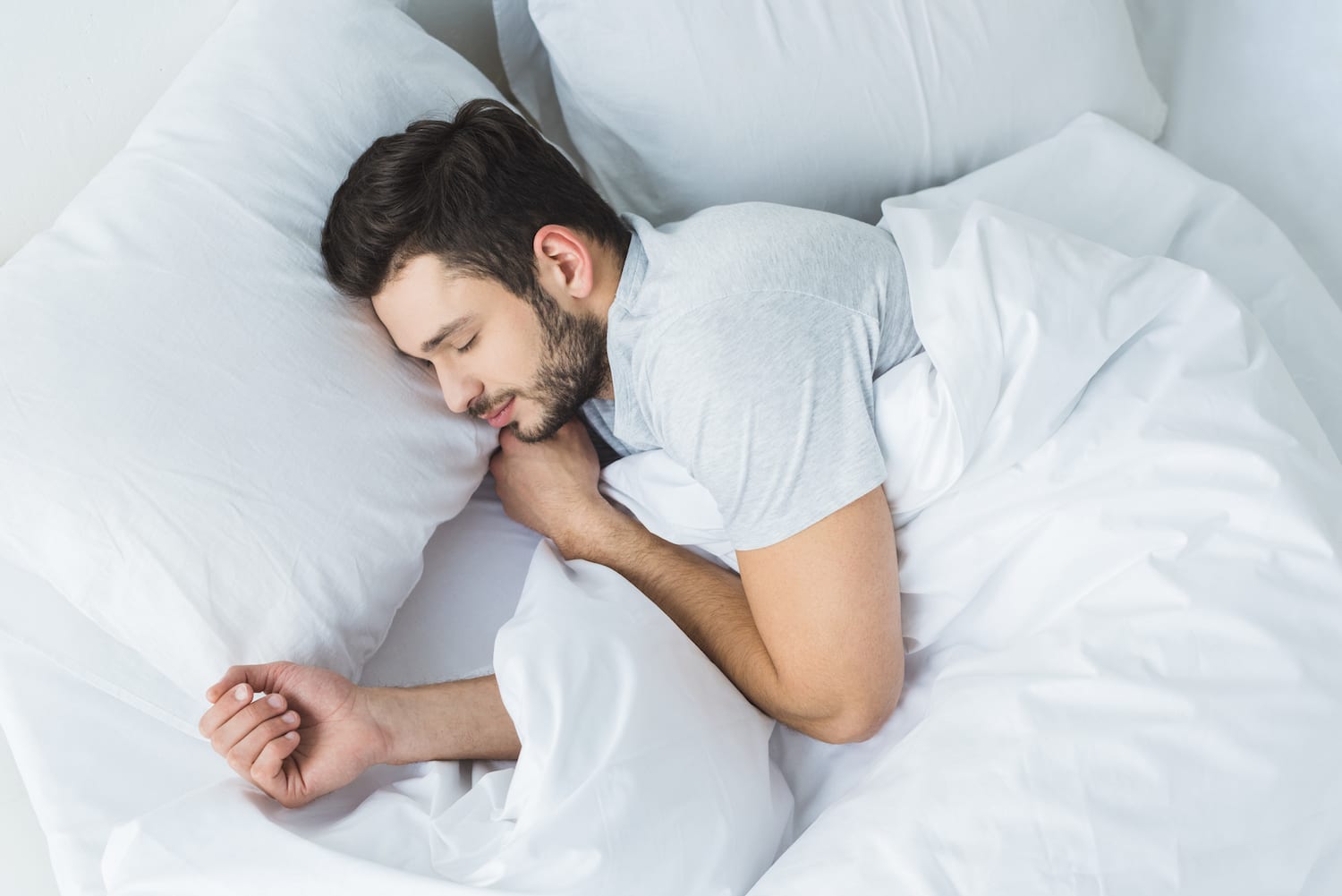 A man sleeping in bed Image