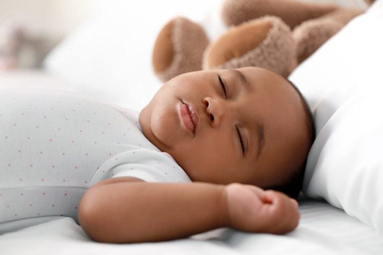 Cute infant baby sleeping on bed