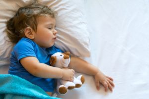 child sleeping in bed