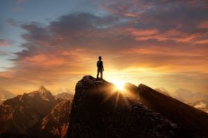 A man standing on top of a mountain