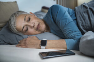 An older woman asleep in bed