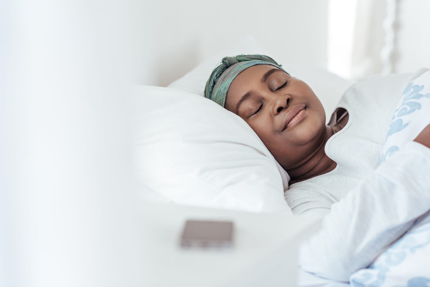 Stock image of a woman sleeping in bed