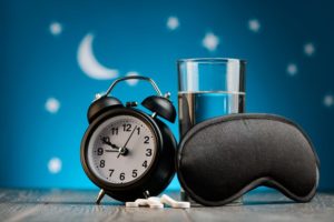 A clock, sleep mask and over the counter sleep tablets