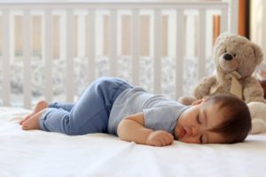 A baby sleeping in a crib