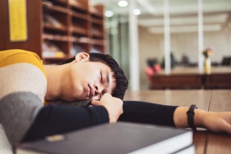 man sleeping in library