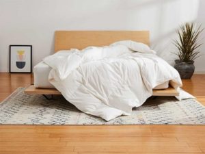 product image of the Brooklinen Comforter draped across a mattress