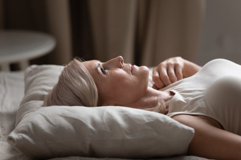 older woman sleeping in bed