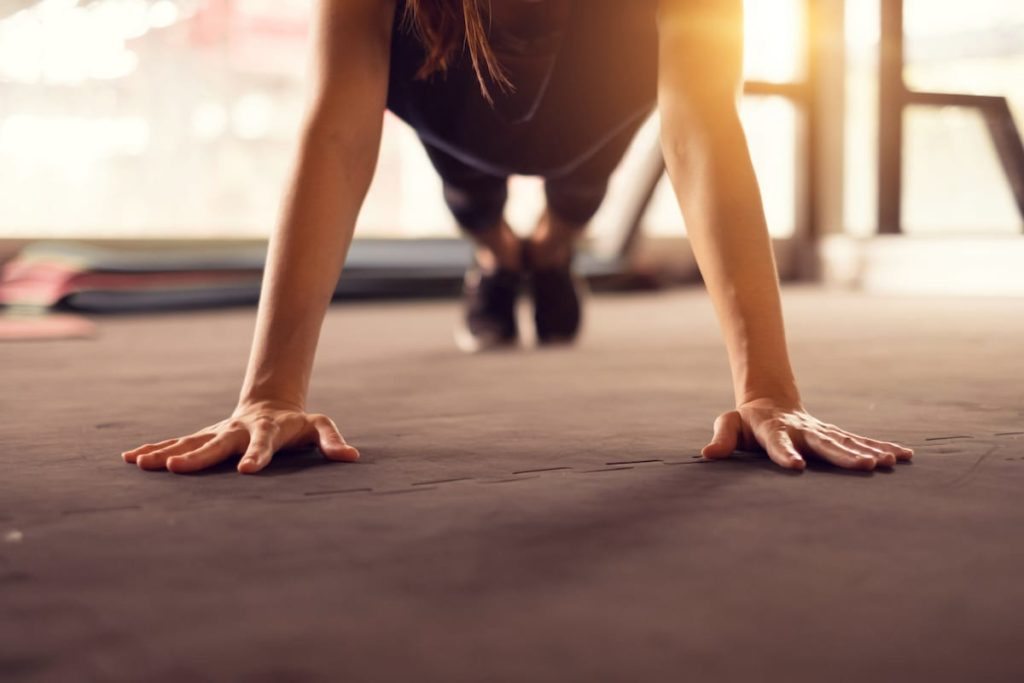 Woman push ups in gym