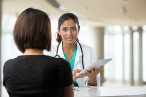woman speaking to doctor about treatment options