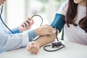 woman getting her blood pressure checked