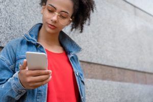 teen using her cell phone