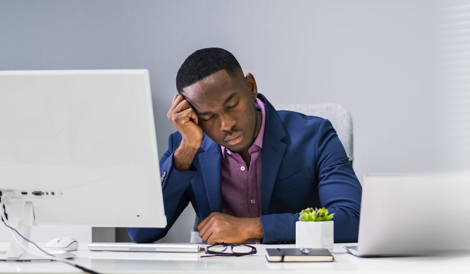 man falling asleep at his desk