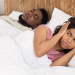 man snoring in sleep, woman annoyed