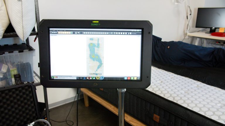 Sleep Foundation tester undergoing side-sleeping pressure mapping on the Brooklyn Bedding Sedona mattress