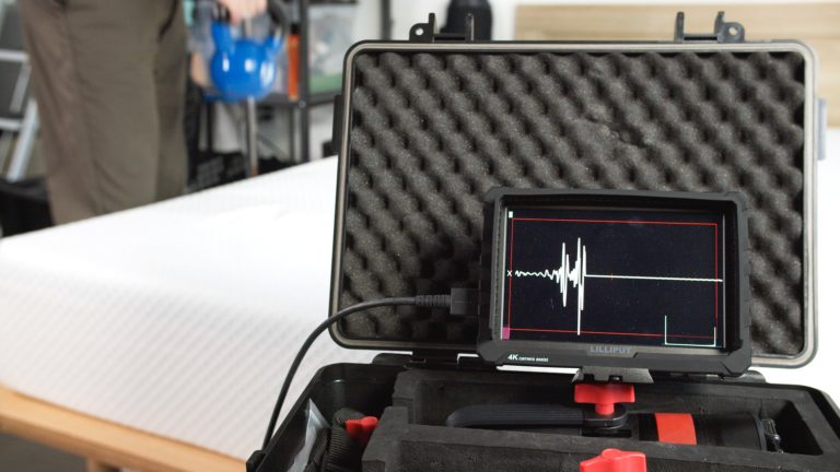 Sleep Foundation testing a Nolah mattress for motion isolation with a kettlebell and motion detection device