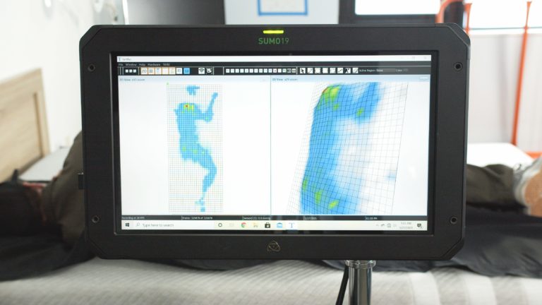 Sleep Foundation tester undergoing side-sleeping pressure mapping on a Leesa mattress