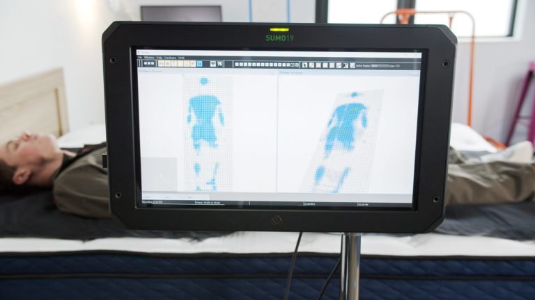 Sleep Foundation tester undergoing back-sleeping pressure mapping on the Silk & Snow Hybrid mattress