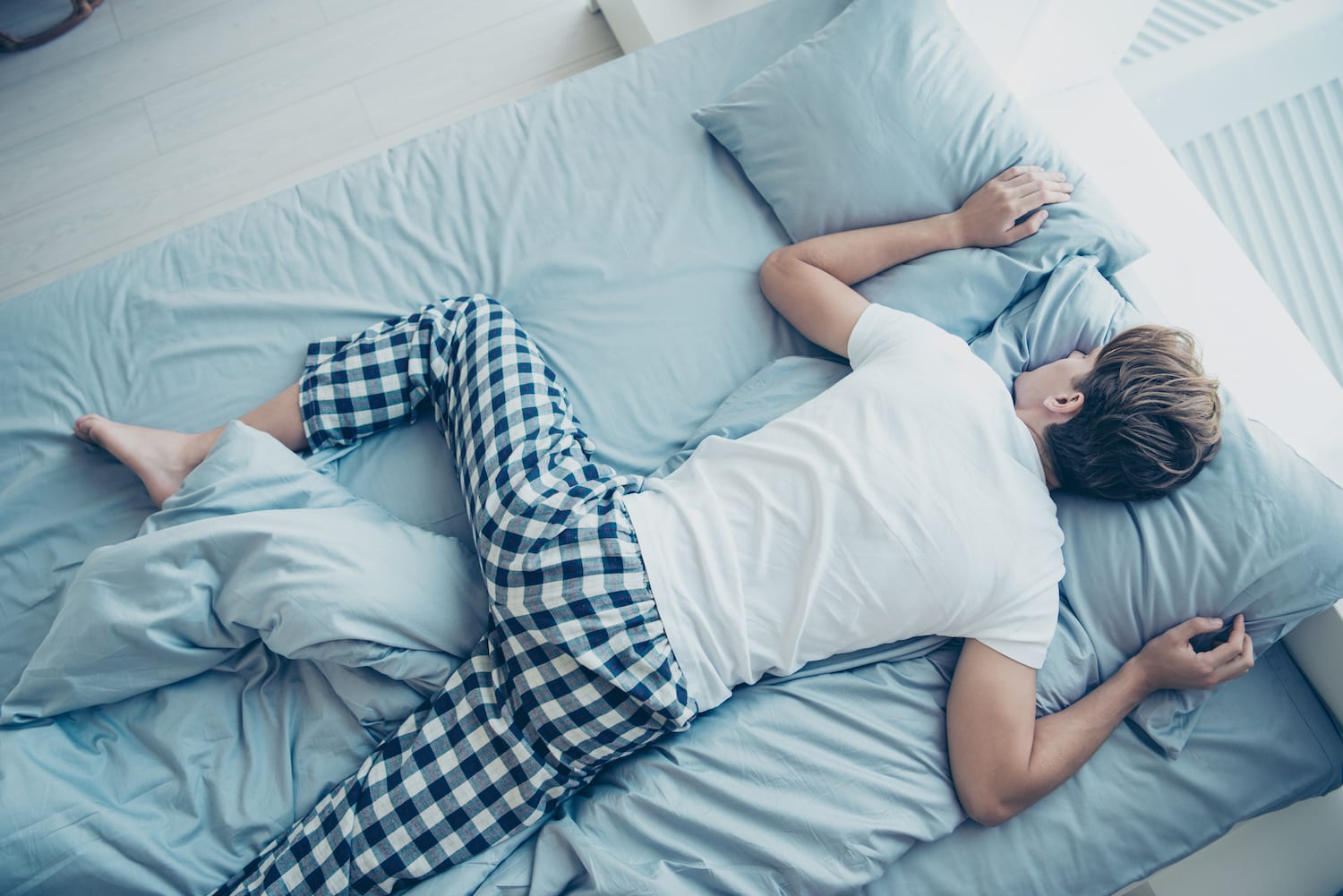 Man stretched out in bed Image