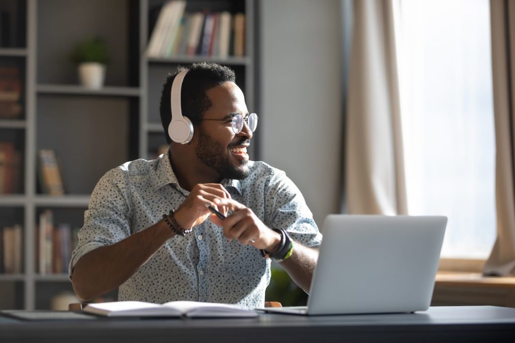 Man working from home with laptop and headphones