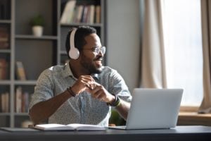 Man working from home with laptop and headphones