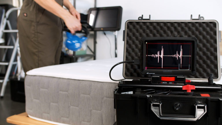 Sleep Foundation testing the Allswell Brick mattress for motion isolation with a kettlebell