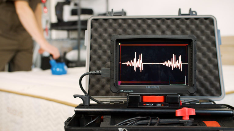 Close-up of motion isolation testing on the Saatva Zenhaven mattress with a kettlebell in the background