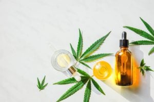 CBD oil and marijuana leaves
