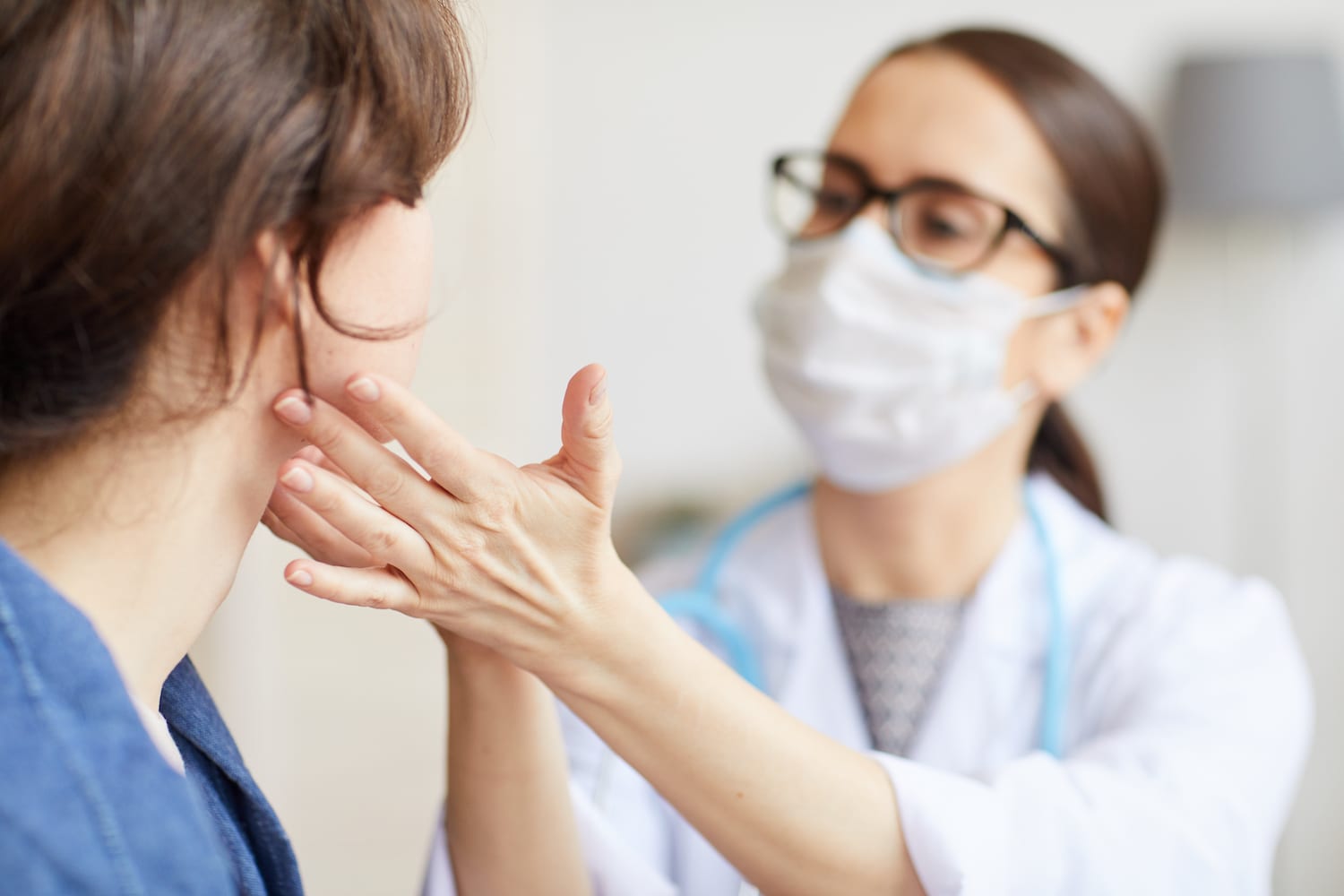 Doctor examining patient's mouth
