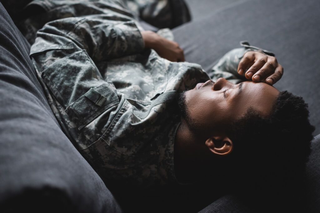 Tired soldier in military uniform sleeping.