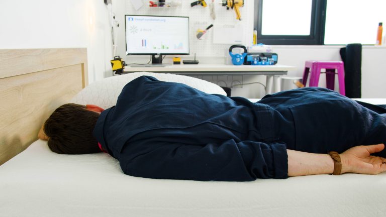 Sleep Foundation tester lying on his stomach on the Zinus Green Tea Memory Foam Mattress