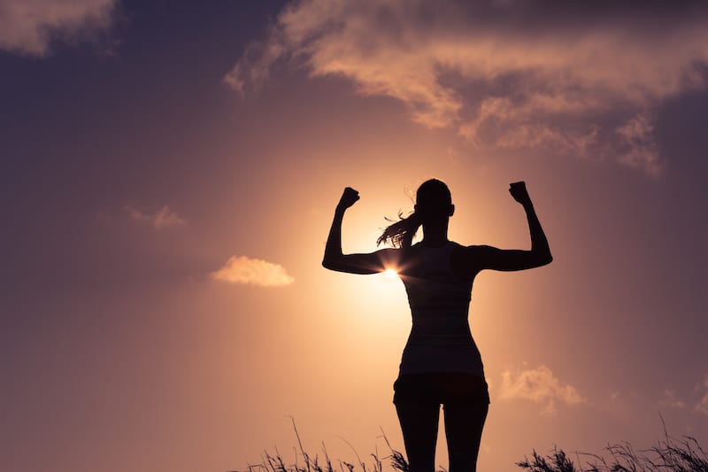 A strong woman flexing muscle