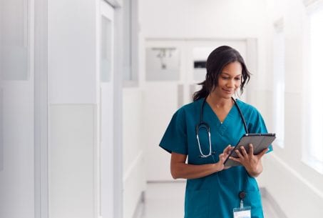 Female doctor looking at tablet