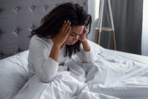 Woman waking up with a headache