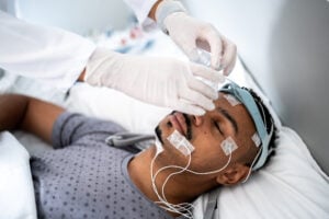 A doctor prepares a patient for a sleep study
