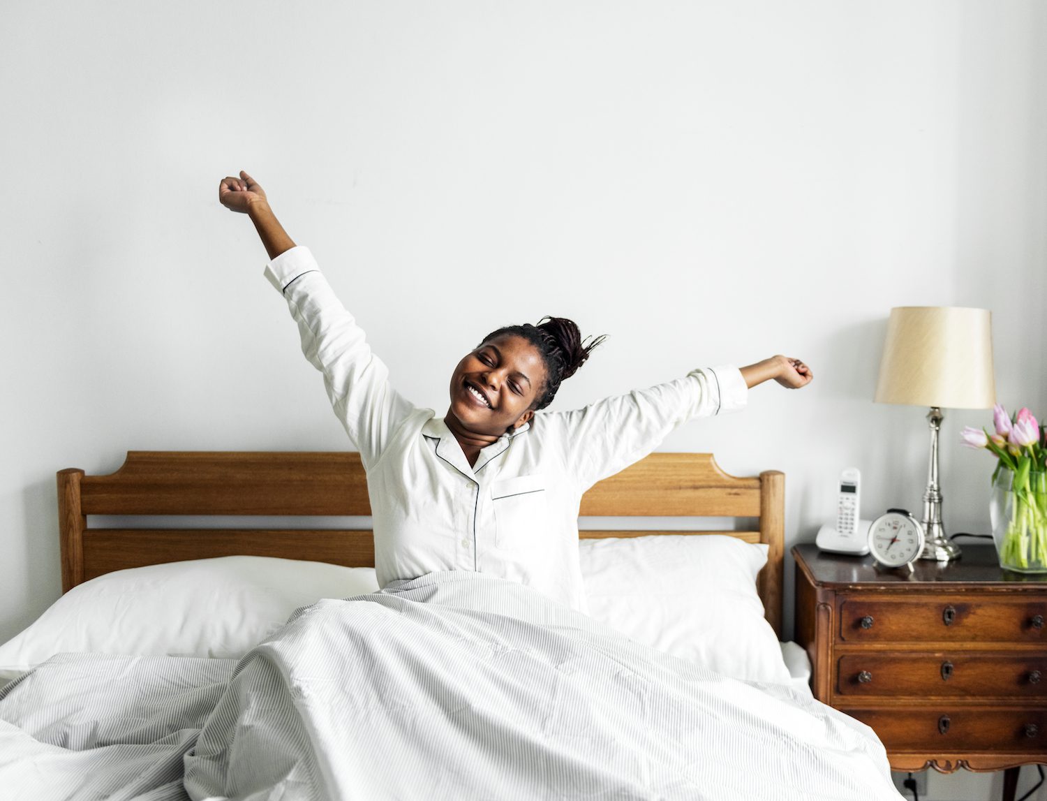 Woman waking up well-rested and stretching