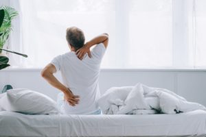 Man waking up with back pain