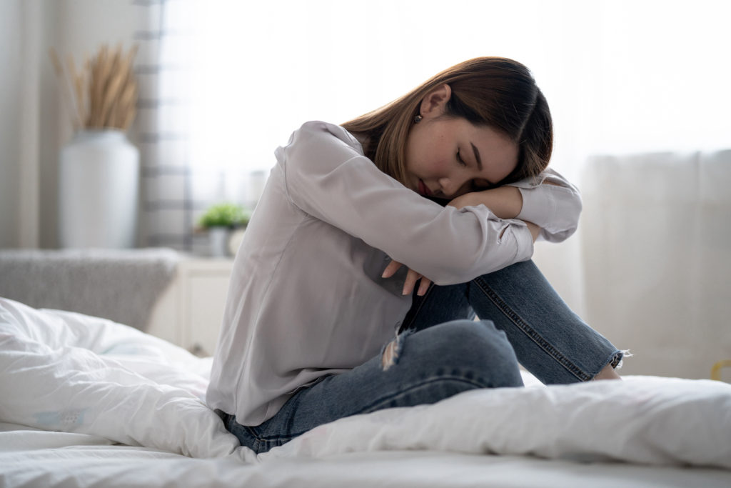 What Causes Insomnia? Woman in bed unable to sleep