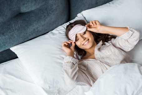 Woman waking up well rested after going to bed early
