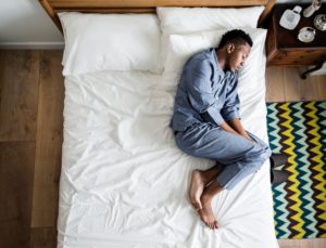 Man sleeping on side in bed