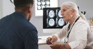 A man discusses head xrays with a health professional