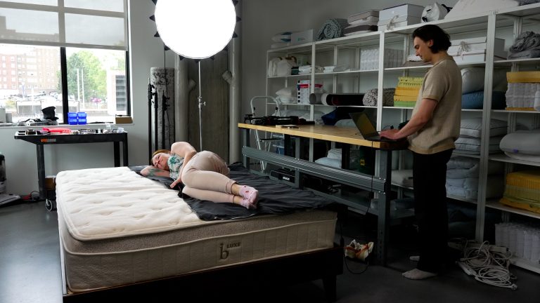 Sleep Foundation tester lying on her stomach the Birch Luxe Natural Mattress