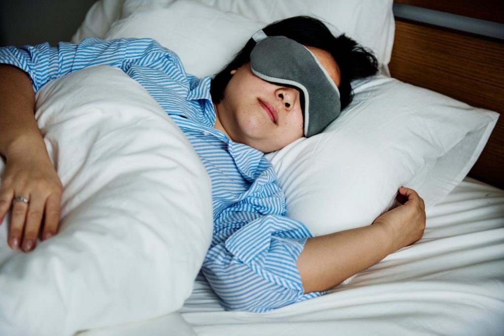 Do Lucid Dream Masks Work? Woman sleeping wearing a dream mask
