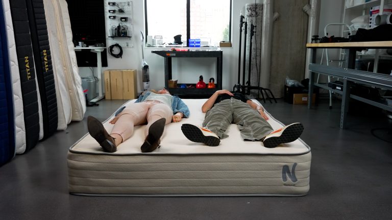 Two Sleep Foundation testers evaluating the Nolah Natural 11 mattress by lying on their backs