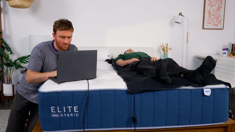 Sleep Foundation tester monitoring pressure mapping while another tester lies on the Bear Elite Hybrid mattress
